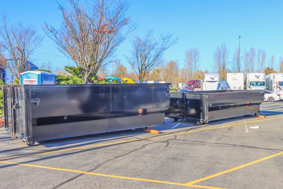 Professional dumpster rental service with roll-off container on residential driveway in Denver
